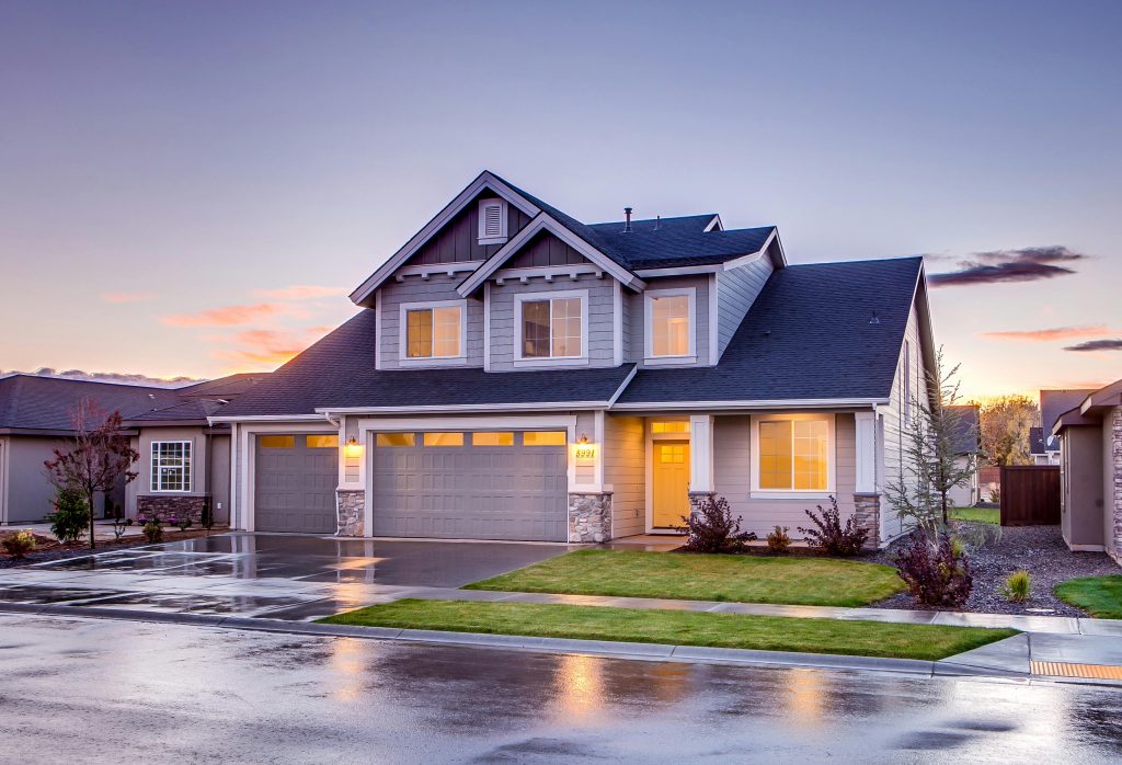 pexels-photo-186077-186077 Elegant suburban home with driveway at sunset showcasing modern architecture.